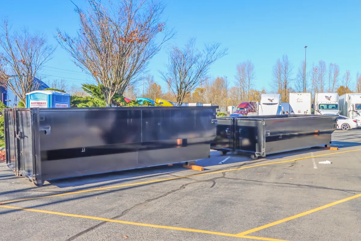 Professional dumpster rental service with roll-off container on residential driveway in White House